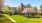 a house with a driveway and trees